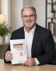 author with holding book at an office table